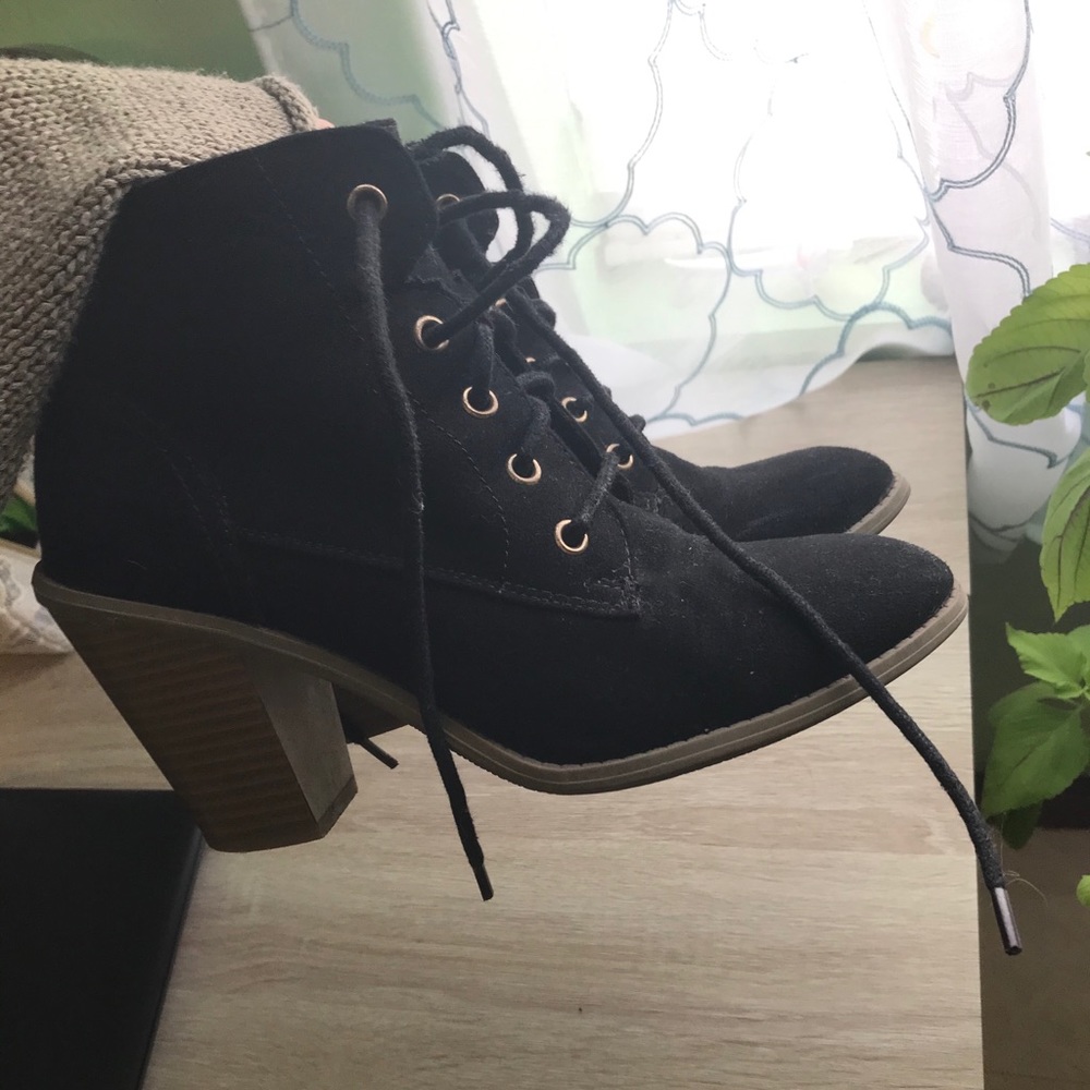Black suede booties with gold accents
